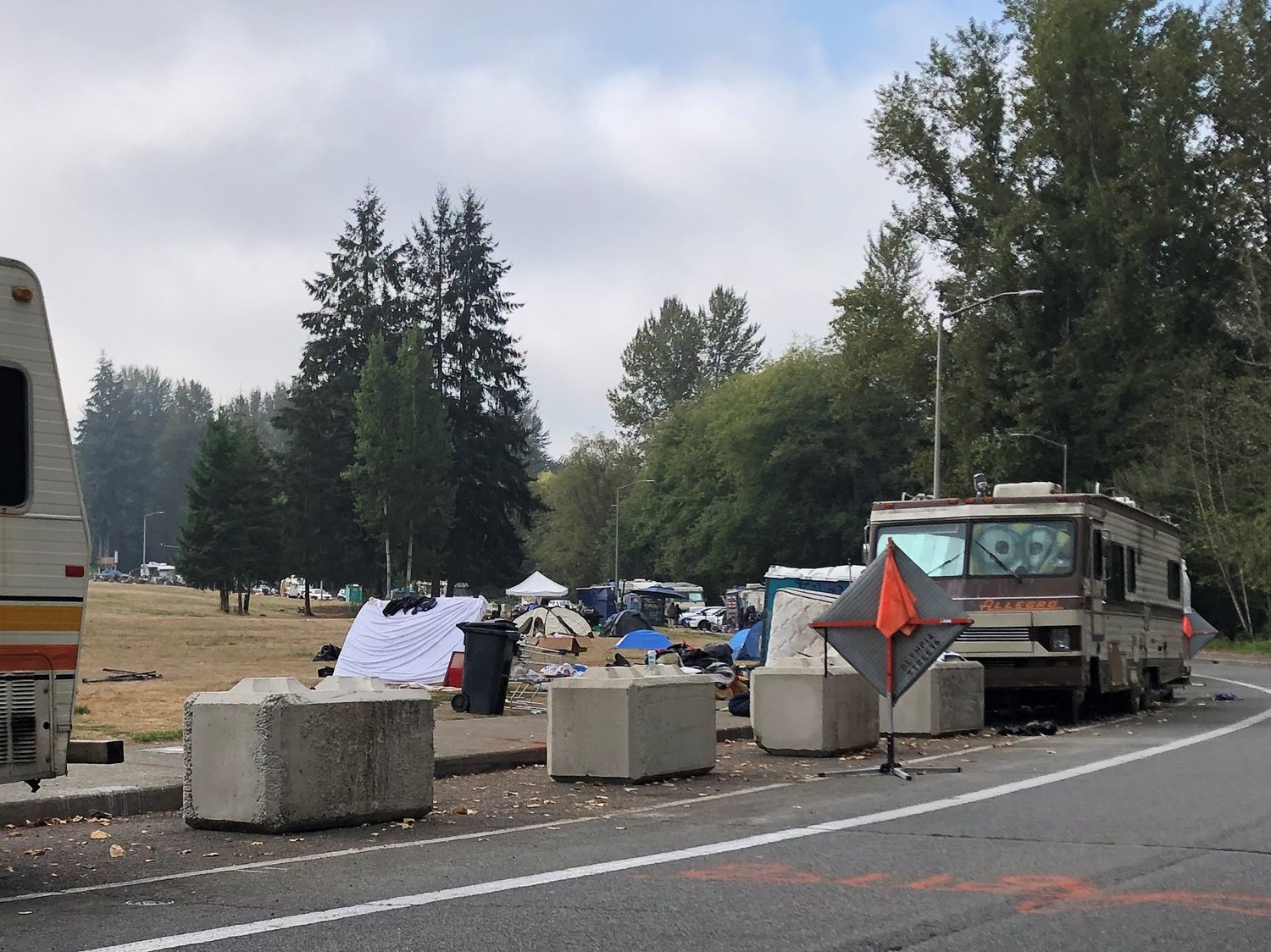 This was part of the Ensign Road Homeless Encampment on October 3, 2022, with tents and debris spread across sections of the field next to the road. Another periodic cleanup is scheduled for October 6, 2022.